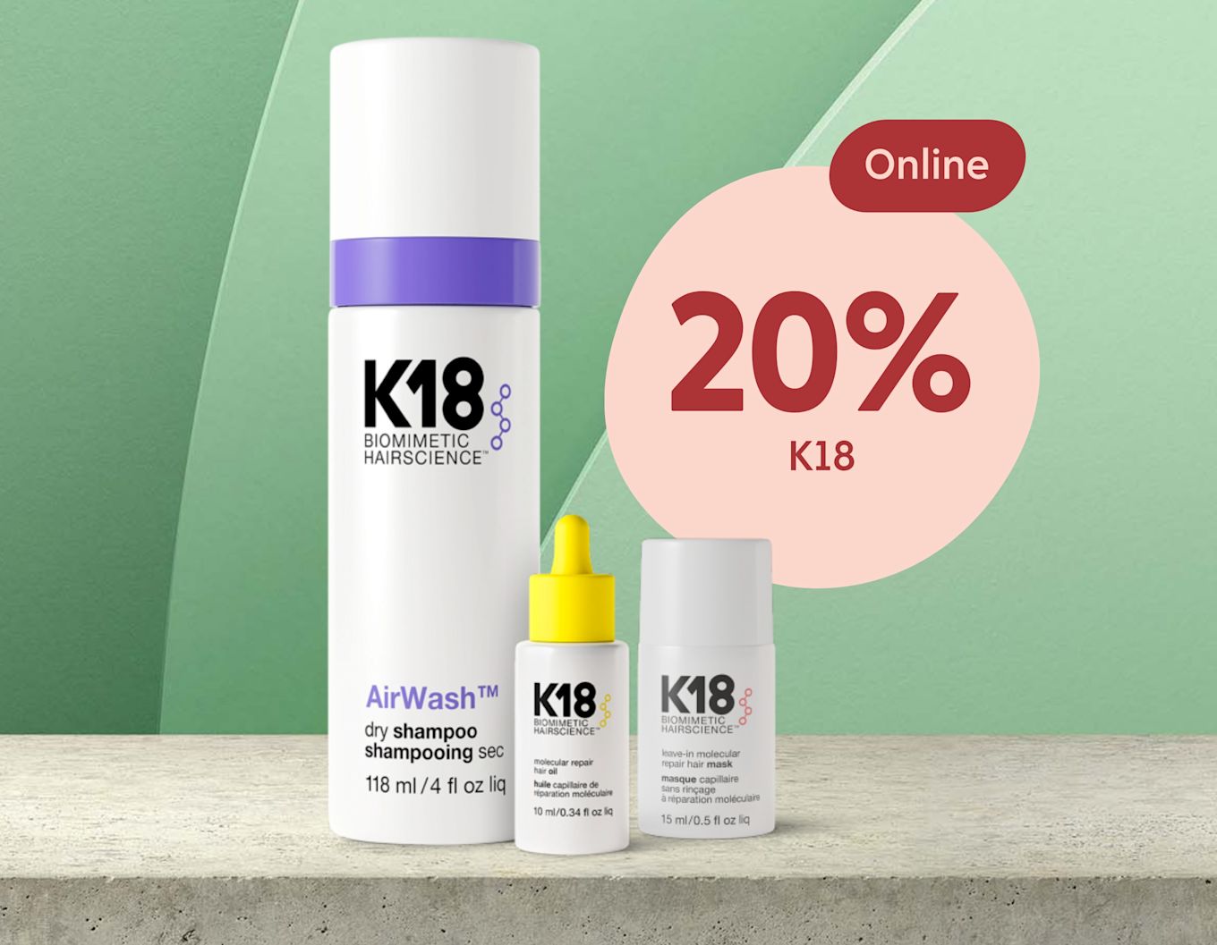 Tre K18 hårvårdsprodukter står på en betongyta med en grön bakgrund och en cirkel med texten "Online 20% K18" bredvid.
